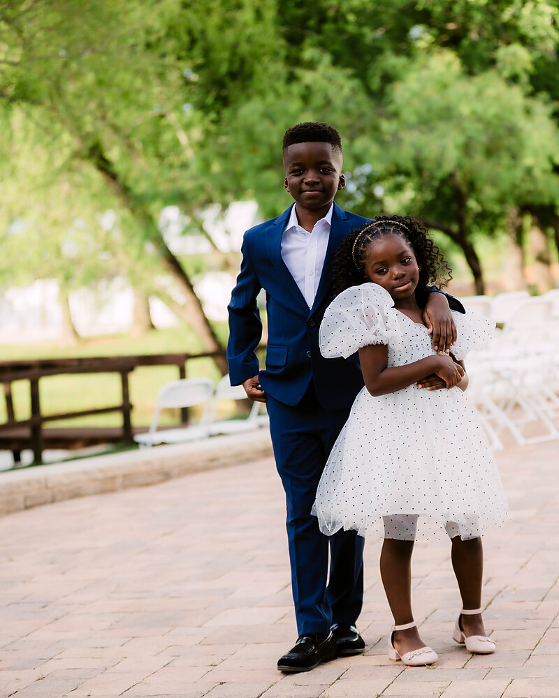 Our son and daughter, dressed up, by the rows of ceremony chairs